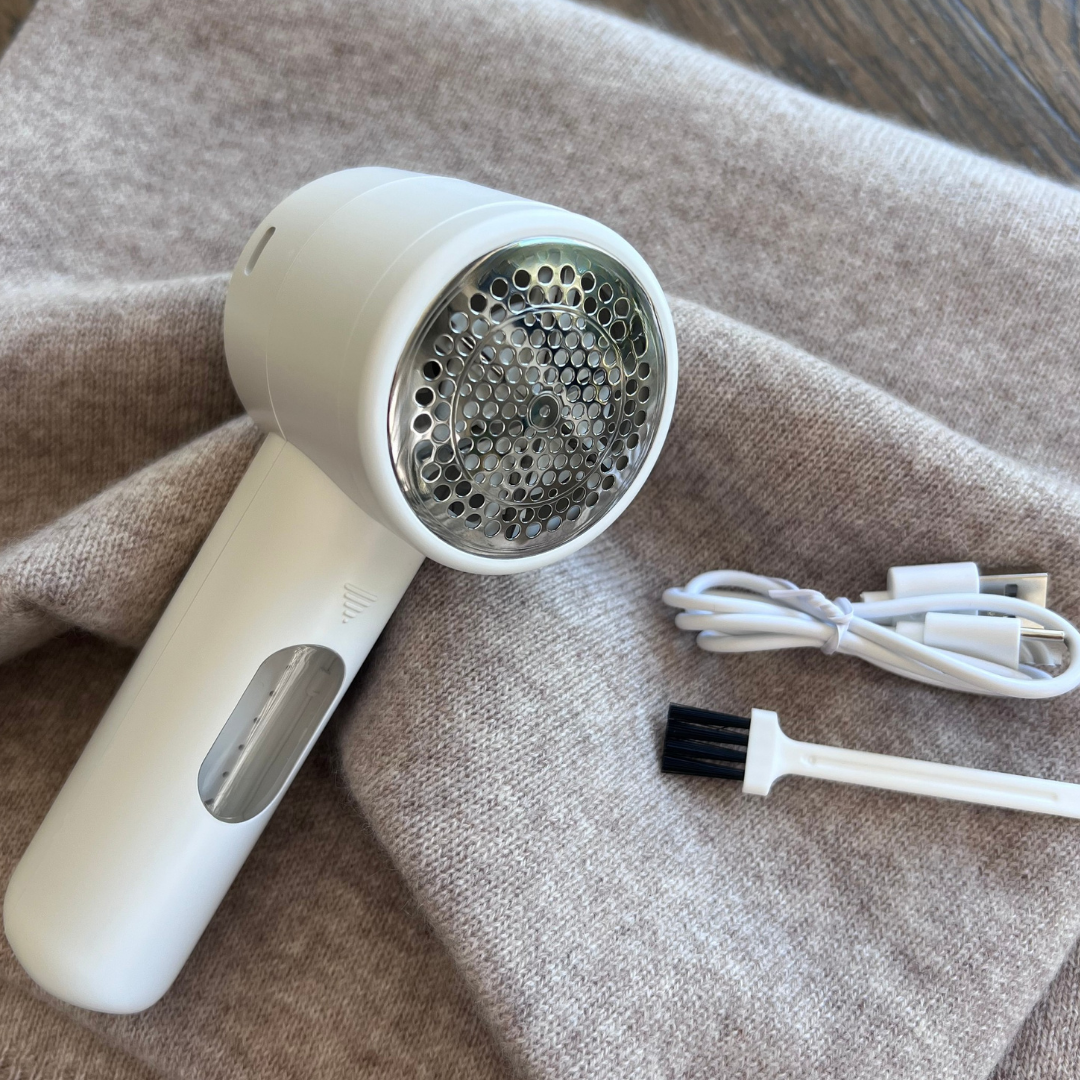 White electric fabric shaver with brush attachment perfect for cashmere care