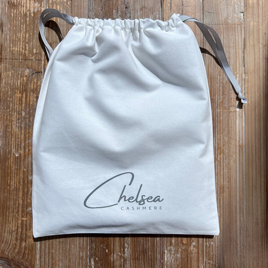 White drawstring bag with 'Chelsea Cashmere' branding