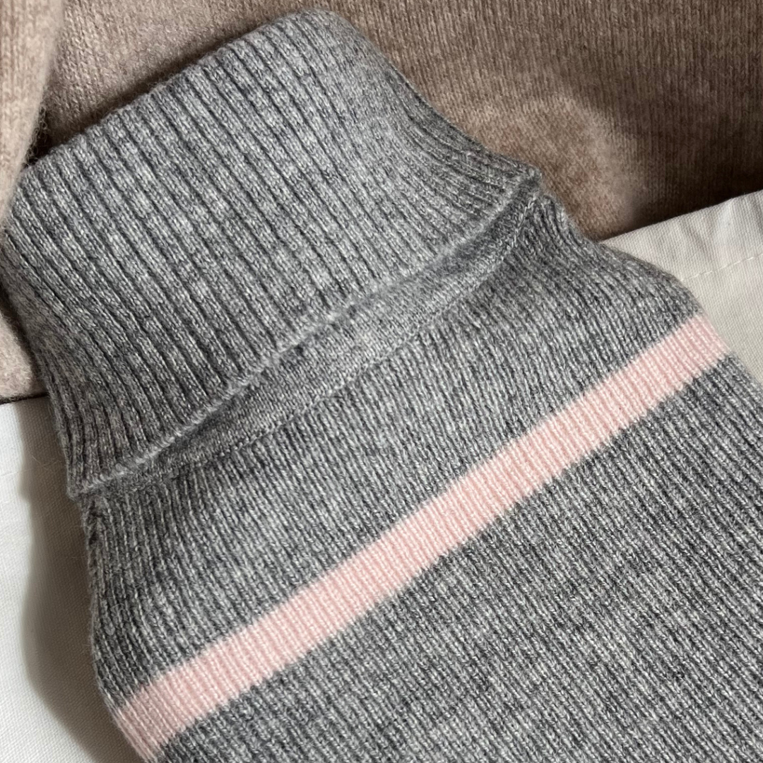 Close-up of grey cashmere hot water bottle with a pink stripe - cashmere rib knit