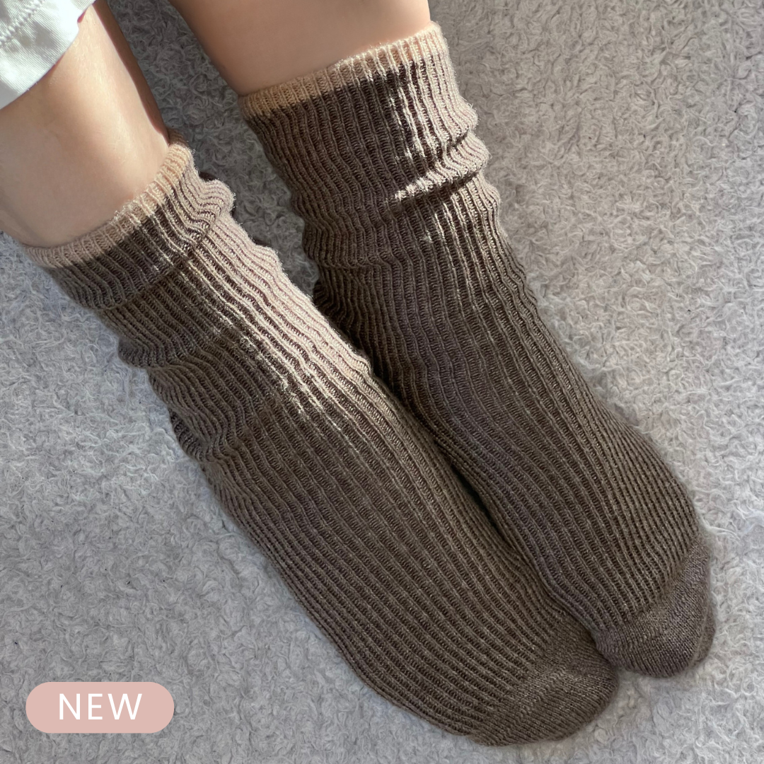 Taupe brown ribbed cashmere socks worn as luxury cashmere lounge socks.