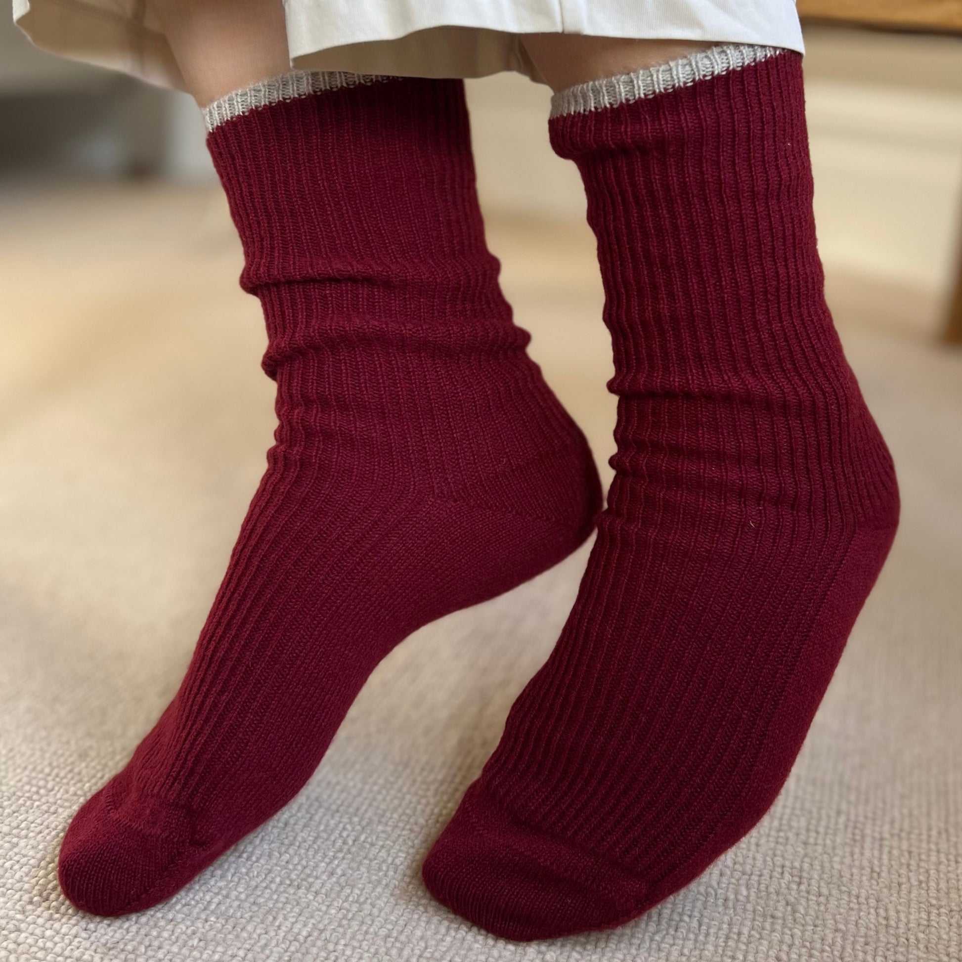 Burgundy cashmere socks worn with lounge clothing
