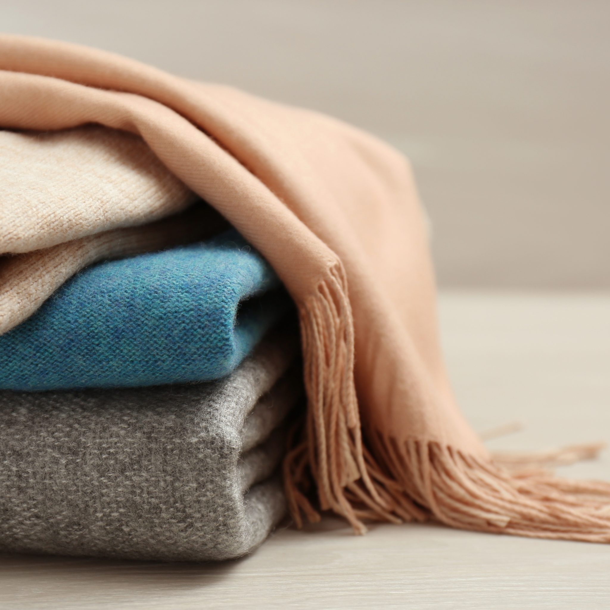 Stack of various coloured grade A cashmere scarves. 